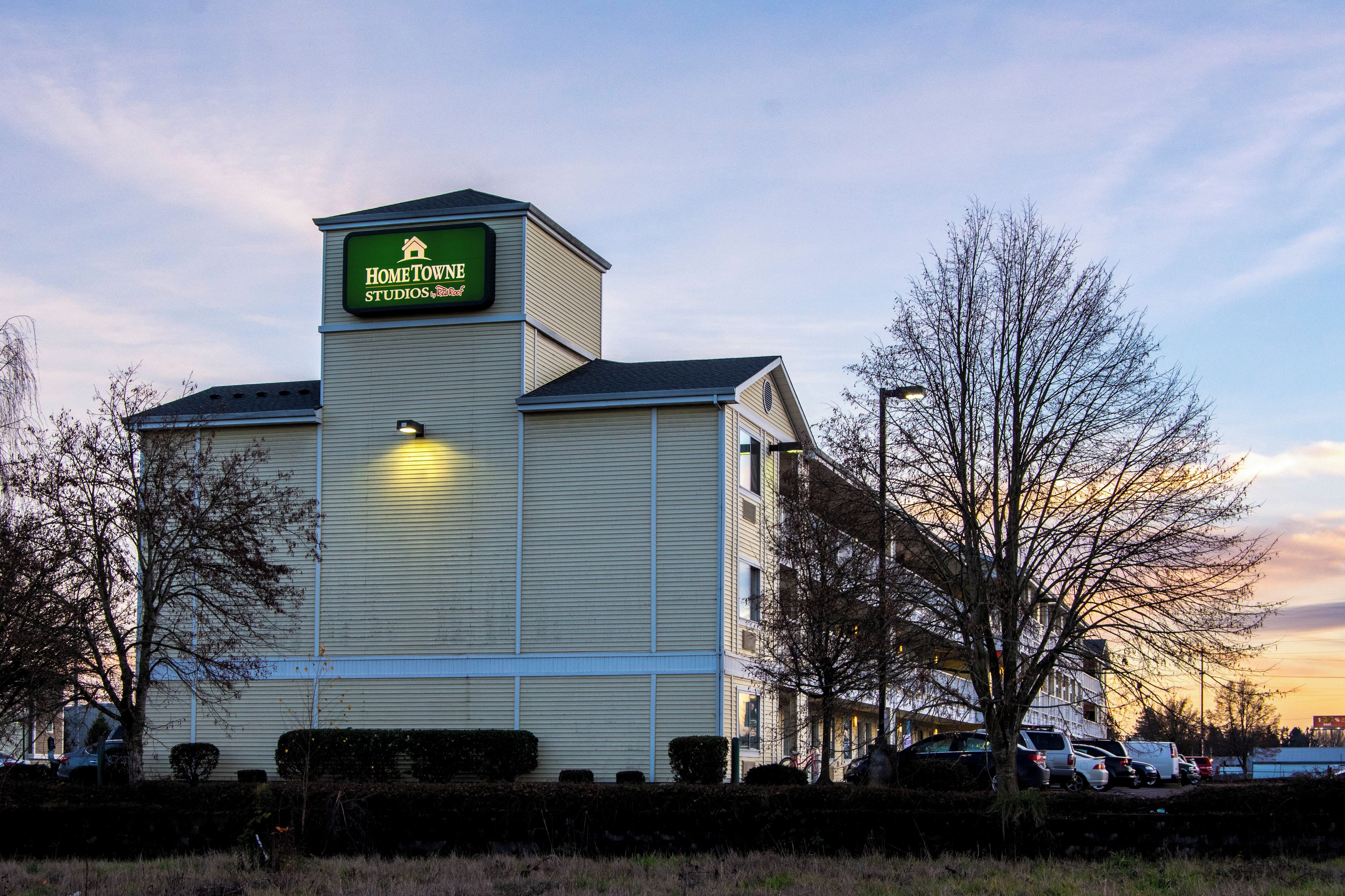 A building with a sign reading 'HomeTown Studios by Red Roof.'