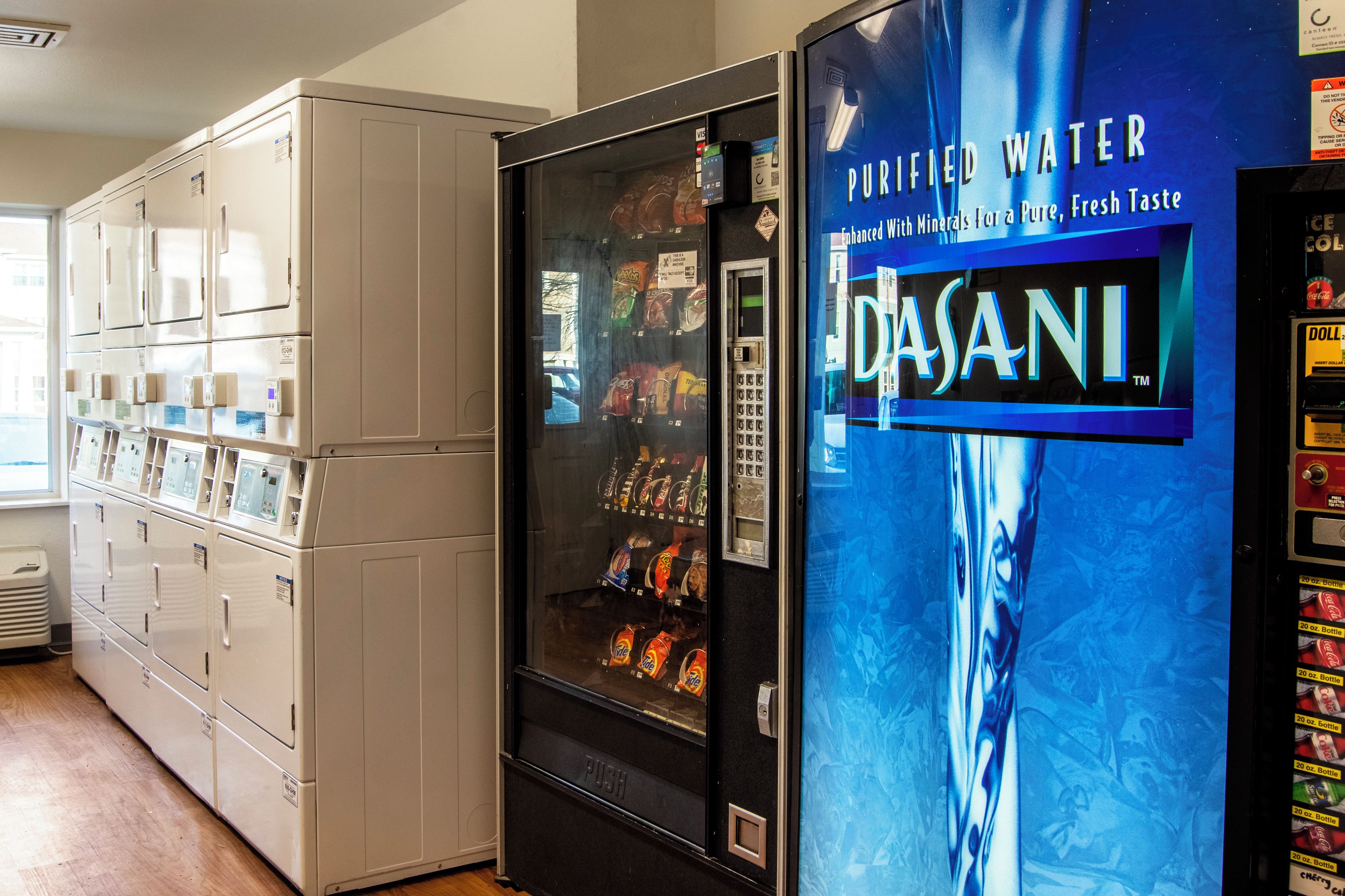 A vending machine with a water dispenser and a soda machine.