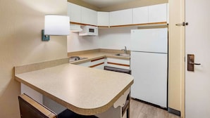 A compact kitchen with white cabinets, a microwave, a refrigerator, and a sink. - Extended Stay America Suites Philadelphia Horsham Dresher Rd (Horsham)