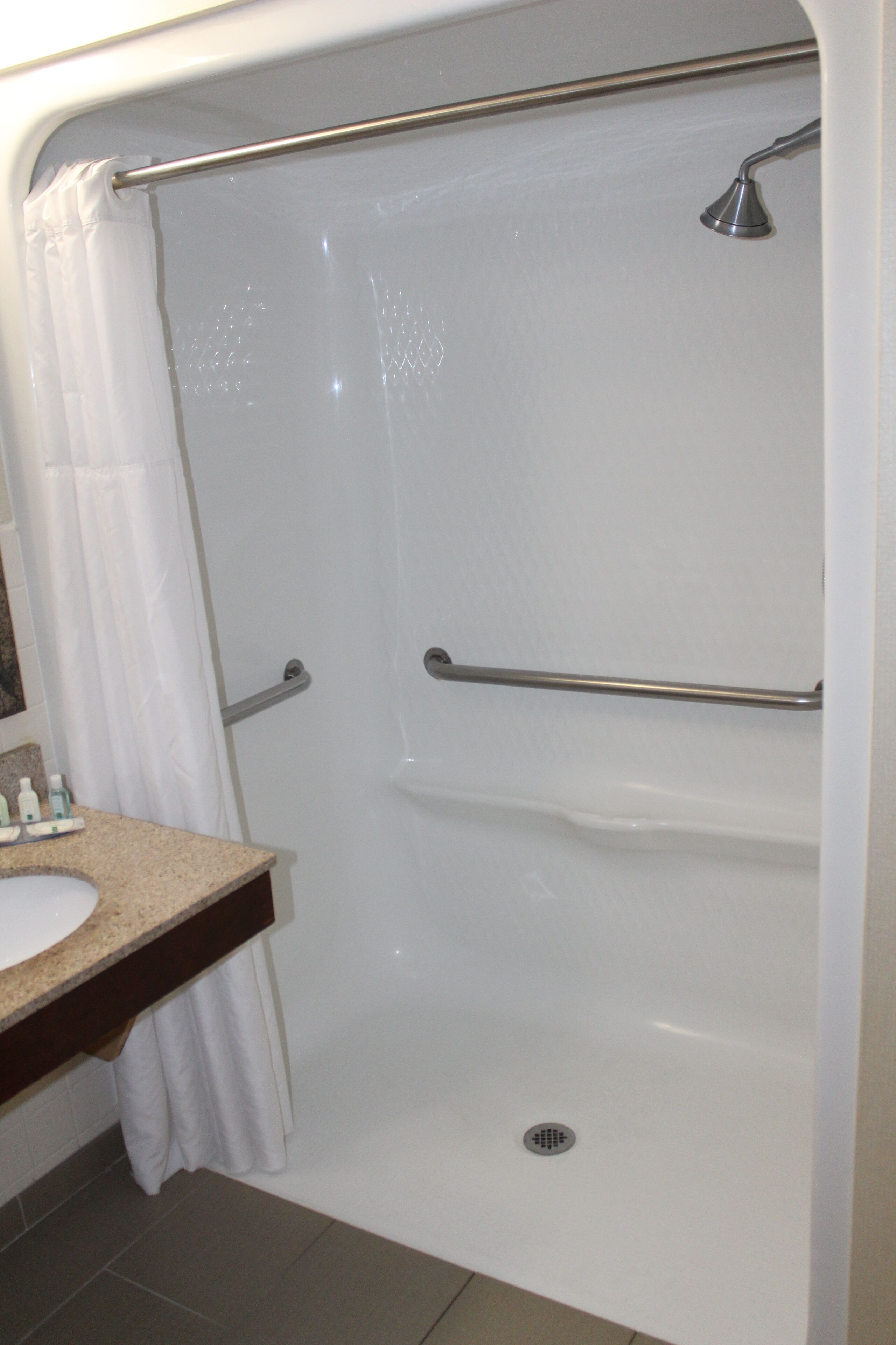 A bathroom with a bathtub, a shower, and a sink.