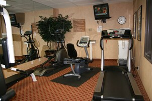A gym with treadmills, stationary bikes, and exercise equipment.