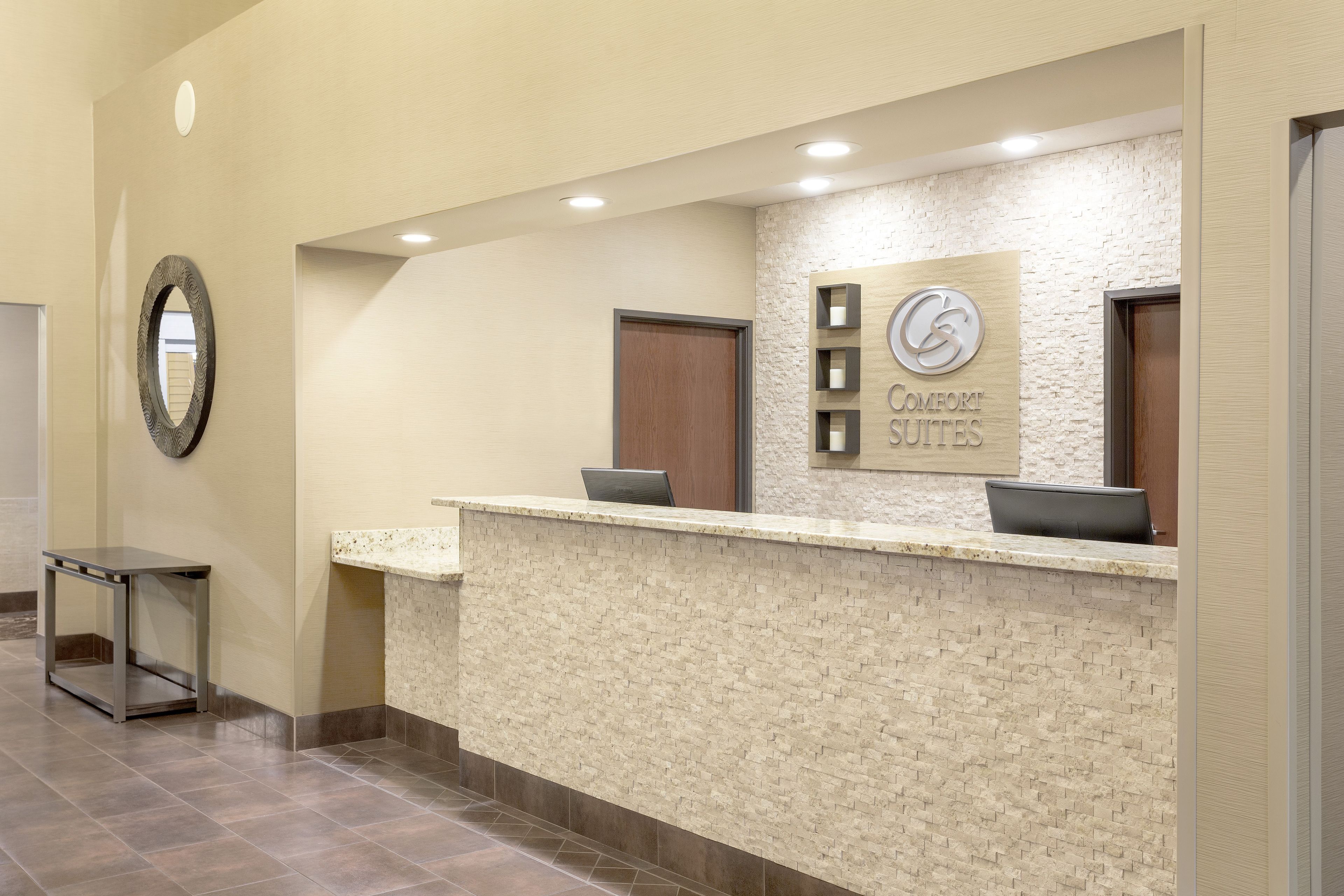 A reception desk with a sign for 'Comfort Suites'.