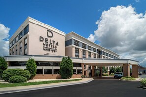 Delta Hotels & Resorts features a modern architectural design with a flat roof and a prominent entrance canopy.