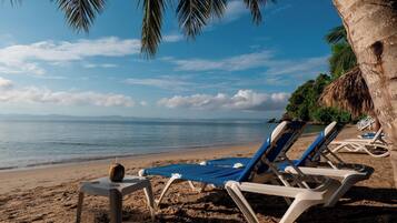 On the beach, sun-loungers, beach umbrellas
