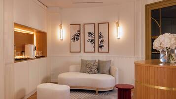 Una sala de estar moderna con un sofá, una mesita y un jarrón decorativo.