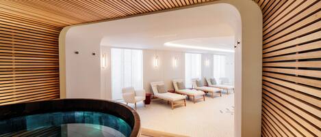A modern spa area with a wooden slatted ceiling, a hot tub, and a seating area with lounge chairs and a sofa.
