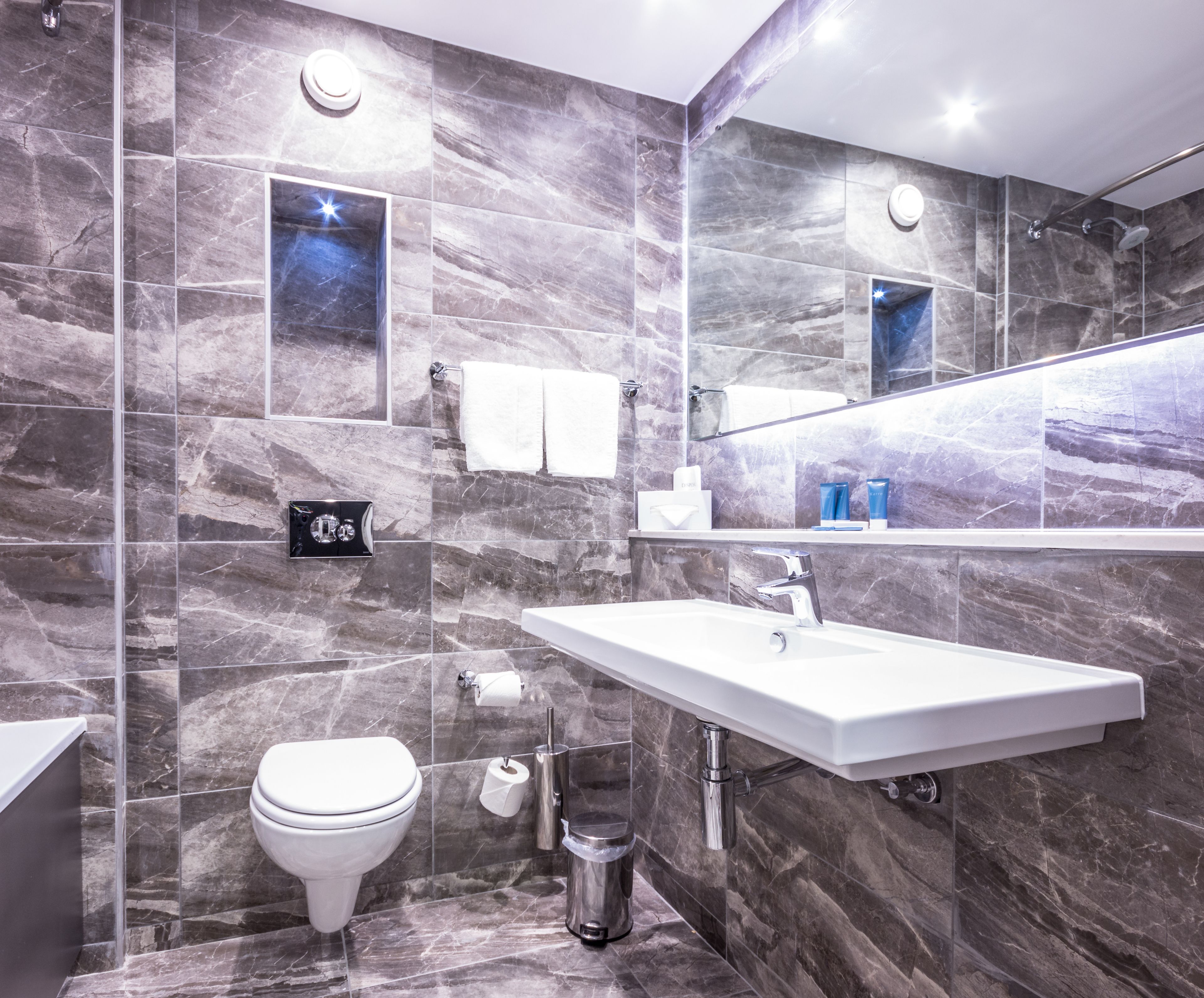 combined shower/bathtub, designer toiletries, hair dryer, towels