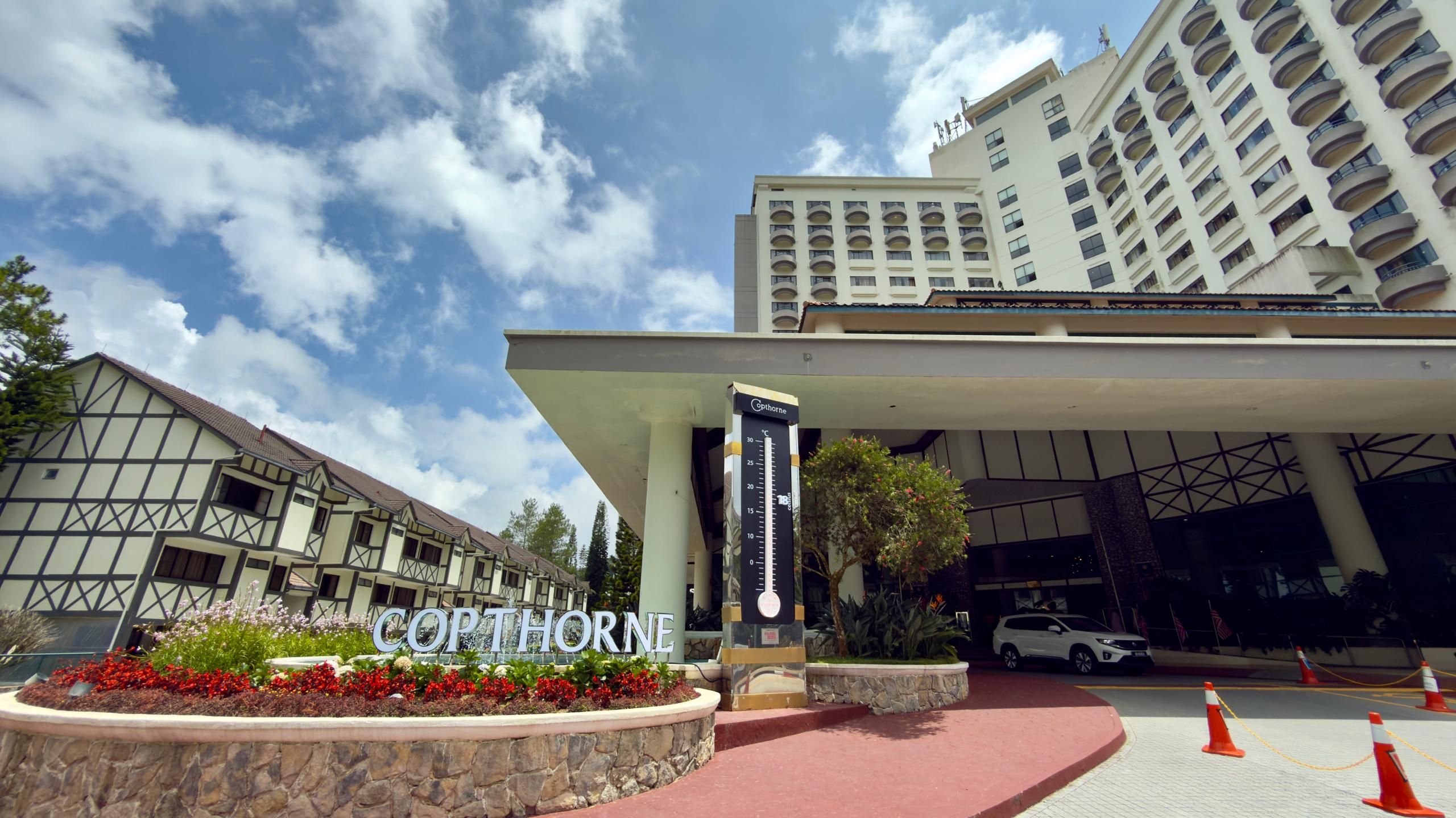 A hotel entrance with a large sign reading 'COPTHORNE' and a temperature display.