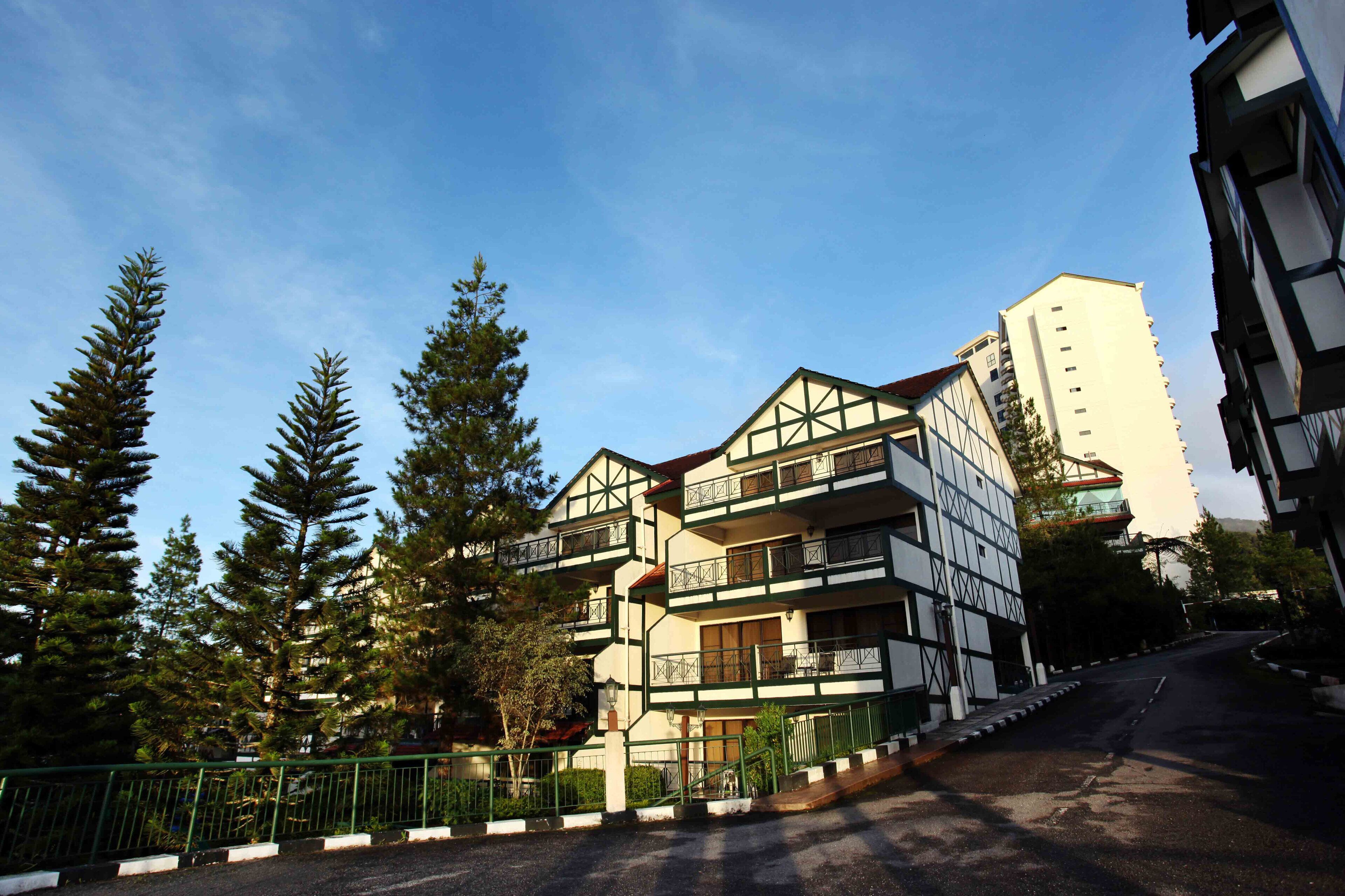 A multi-story building with a traditional architectural style, featuring balconies and a central courtyard.