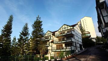 A multi-story building with a traditional architectural style, featuring balconies and a central courtyard.