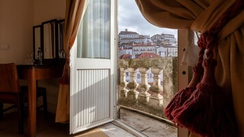 Una habitación con vista a un paisaje urbano a través de una puerta abierta.