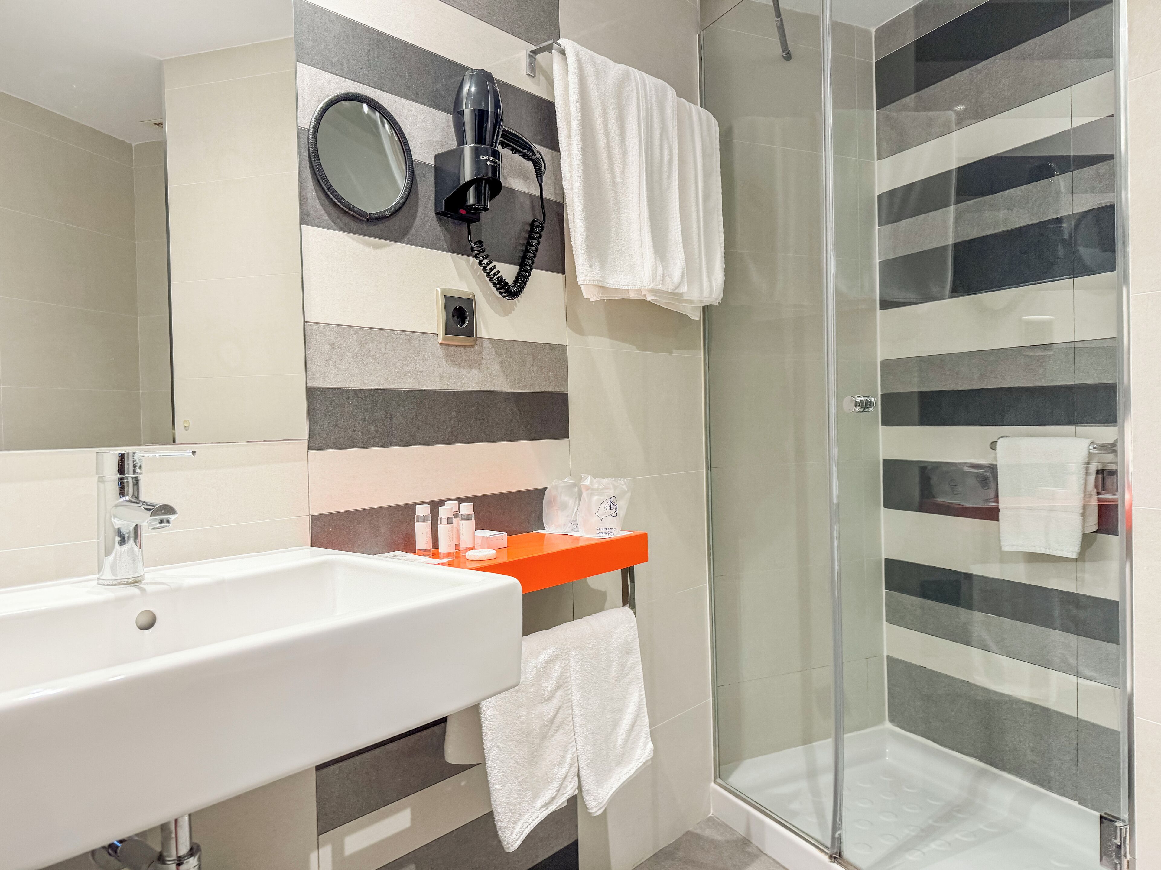 functional interior single room | bathroom | shower, rainfall showerhead, free toiletries, hair dryer