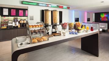 A breakfast buffet with various food items and a coffee station.