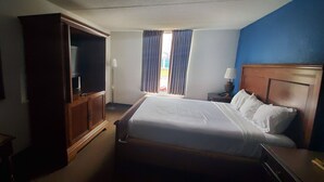 A hotel room with a large bed, a wardrobe, a desk, and a window with curtains. - FairBridge Inn Express Indianapolis South (Indianapolis)