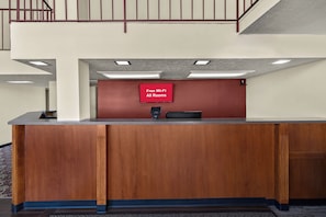 A reception desk with a sign indicating free Wi-Fi in all rooms. - Red Roof Inn & Suites Cave City (Cave City)