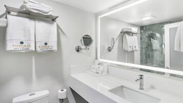 Un baño moderno con un espejo grande, dos lavamanos y un inodoro.