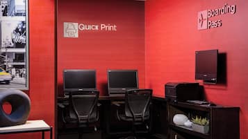 A room with two desks, two monitors, and a 'Quick Print' sign.
