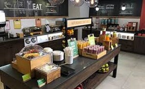 A breakfast bar with various food items and beverages. - Hampton Inn Swedesboro Philadelphia (Swedesboro)
