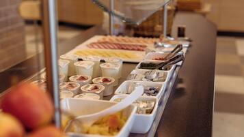 A buffet with various food items and containers.