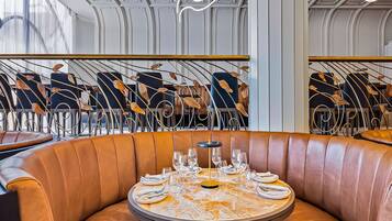 Enjoy meals in style at this dining area with a round table and comfortable leather booth.