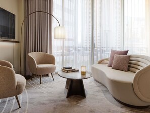 A modern living room with a sofa, armchairs, a coffee table, and a floor lamp. - The Playford Adelaide MGallery (Adelaide)