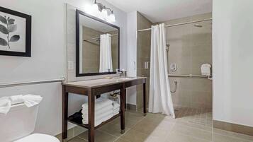 A bathroom with a toilet, sink, and shower.