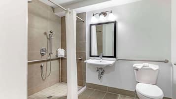 A modern bathroom with a walk-in shower, a sink with a mirror, and a toilet.