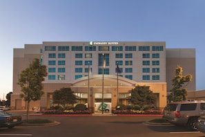 A modern building with a sign reading 'EMBASSY SUITES' at the entrance. - Embassy Suites by Hilton Portland Airport (Portland)