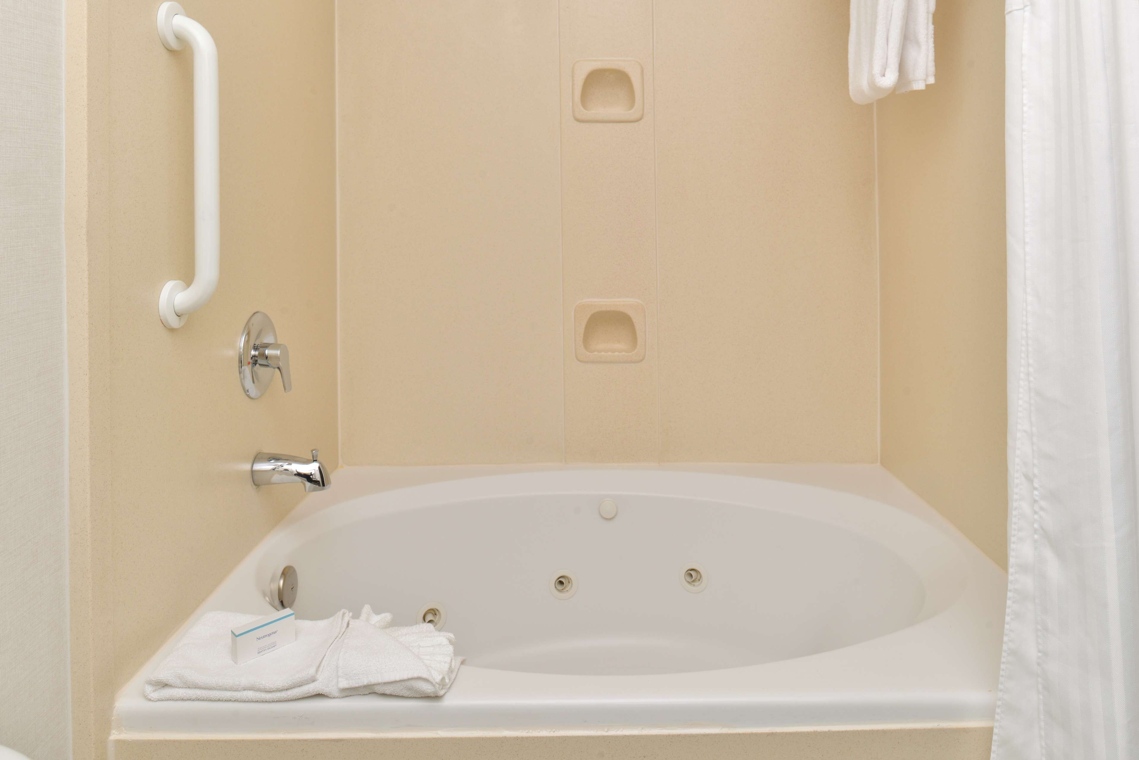 room, 1 king bed with sofa bed, jetted tub | bathroom | hair dryer, towels