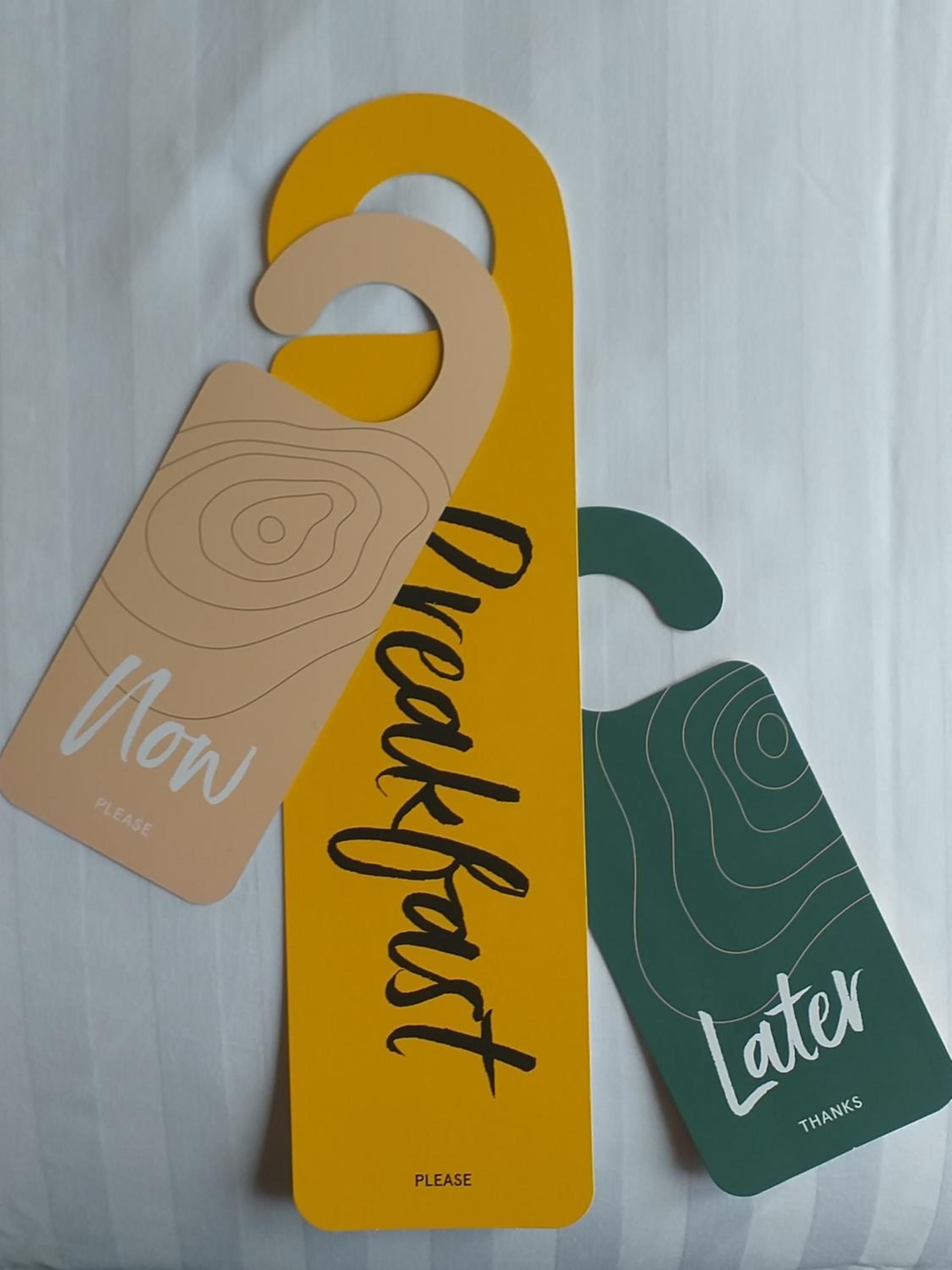 Two hangtags with 'Now' and 'Later' text, and 'Please' on a white background.