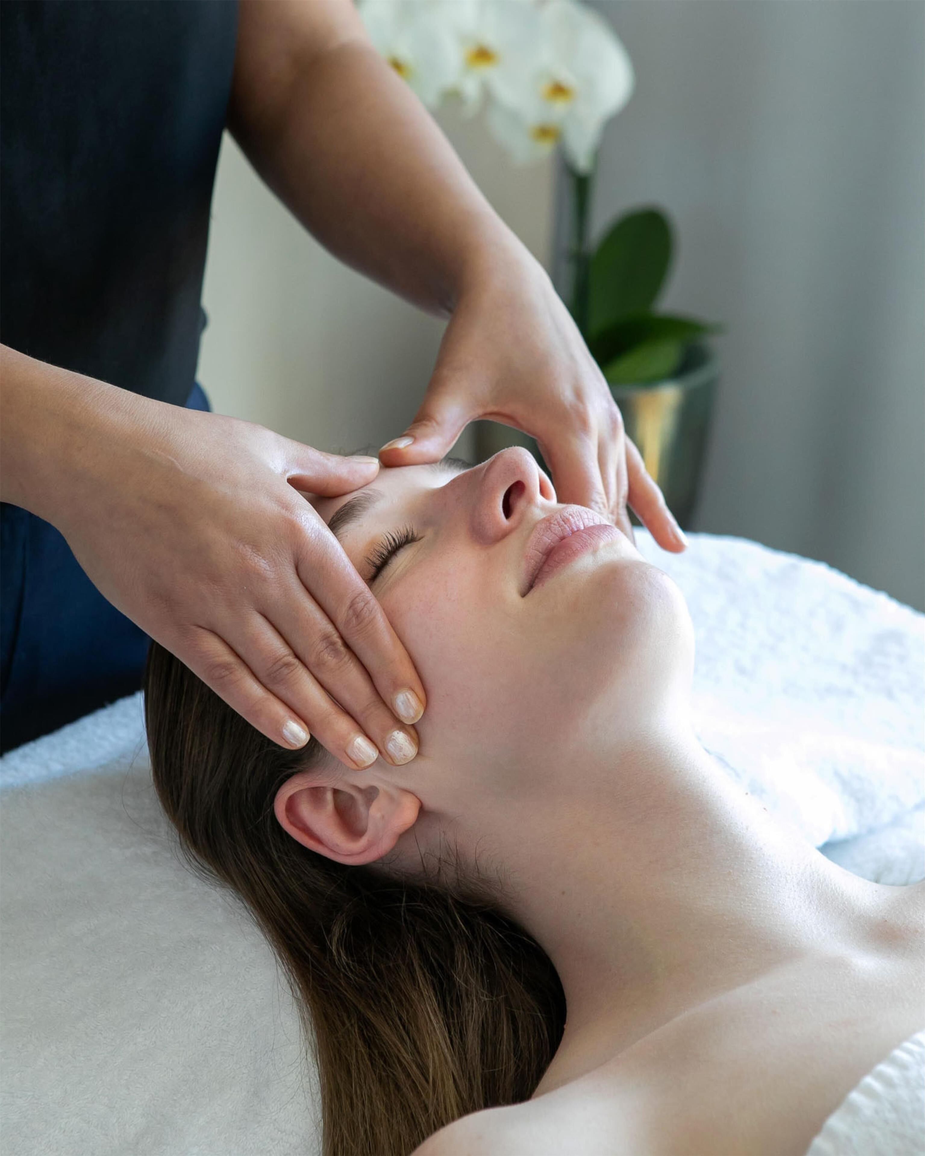 A person receiving a head massage.