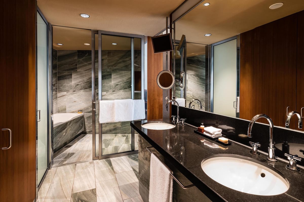 deluxe room, 1 king bed | bathroom | separate bathtub and shower, rainfall showerhead, hair dryer, bathrobes