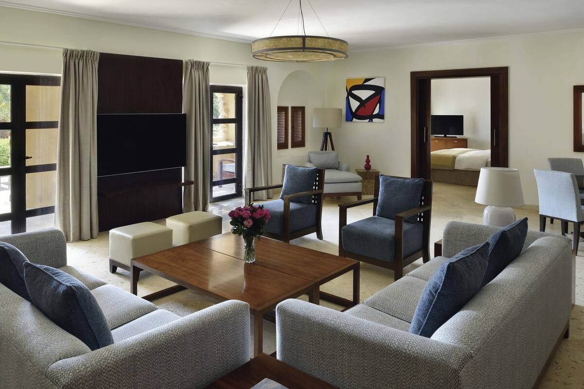 A spacious living room with a sofa set, a coffee table, and a TV.