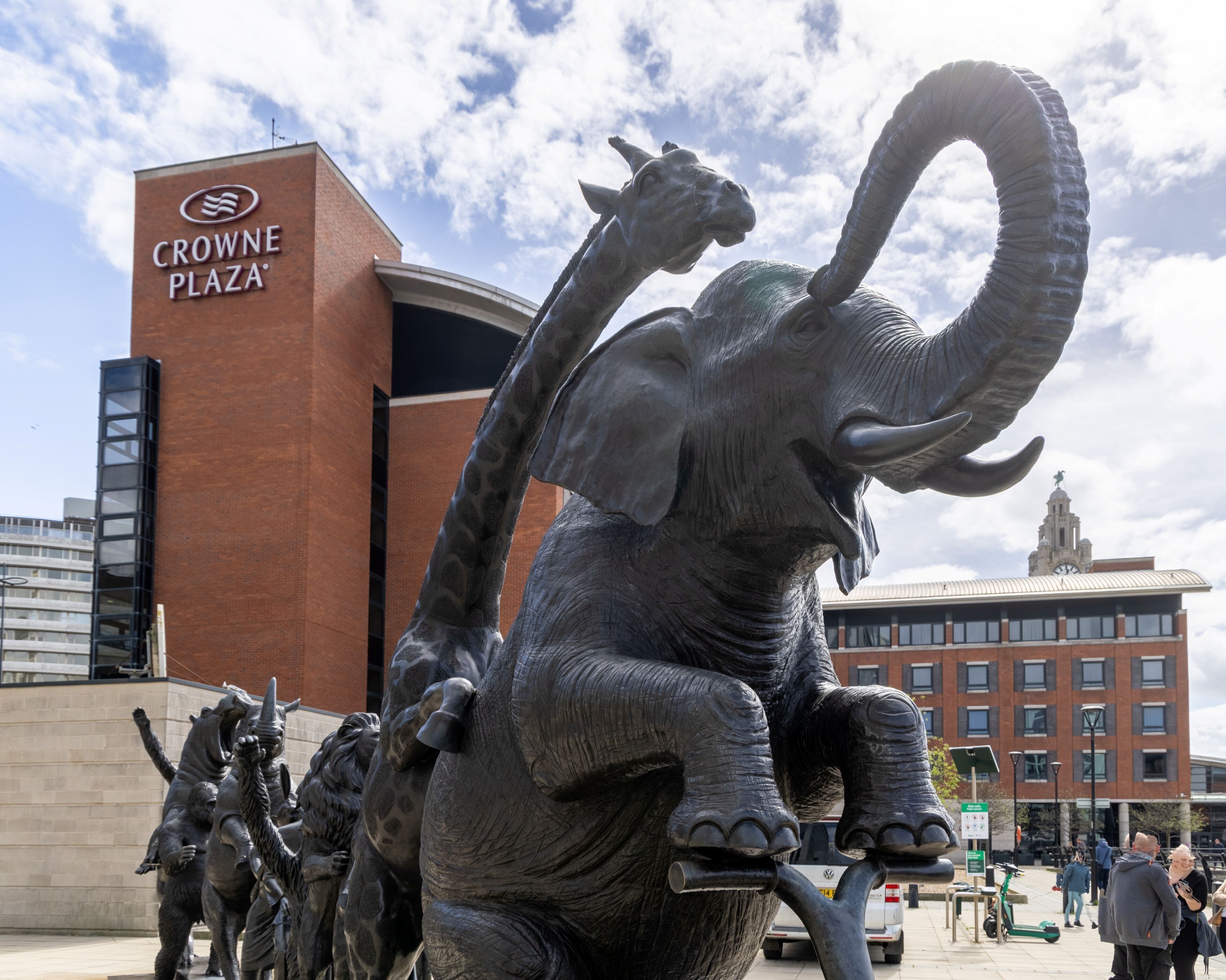 A bronze elephant sculpture in front of Crowne Plaza.