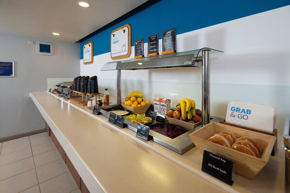 A buffet counter with various food items and a sign indicating 'Grab & Go' service. - Holiday Inn Express Taunton East by IHG (Taunton)