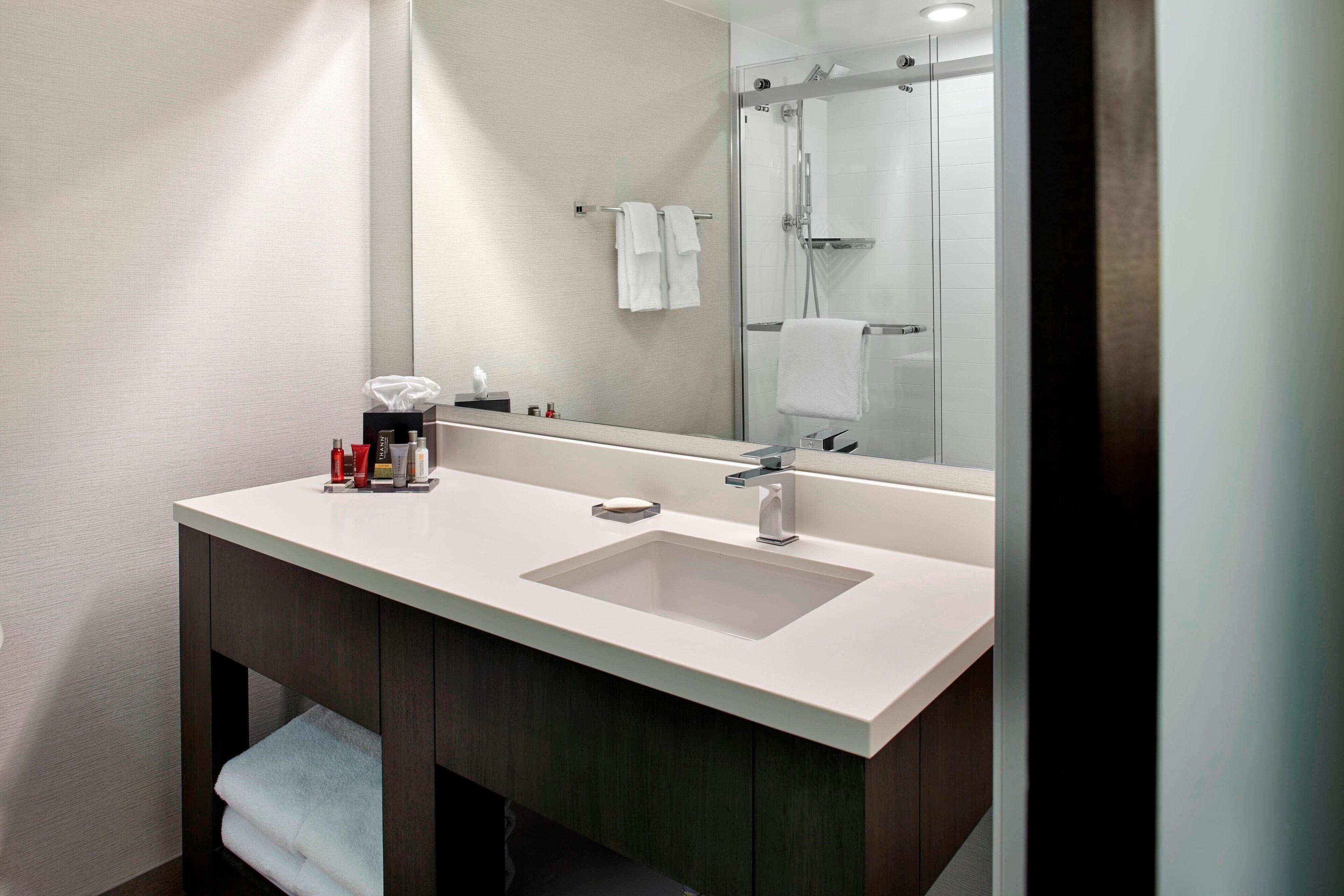 combined shower/bathtub, designer toiletries, hair dryer, towels