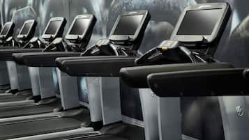 A row of stationary bikes with digital screens and a FlexDeck shock absorption system.