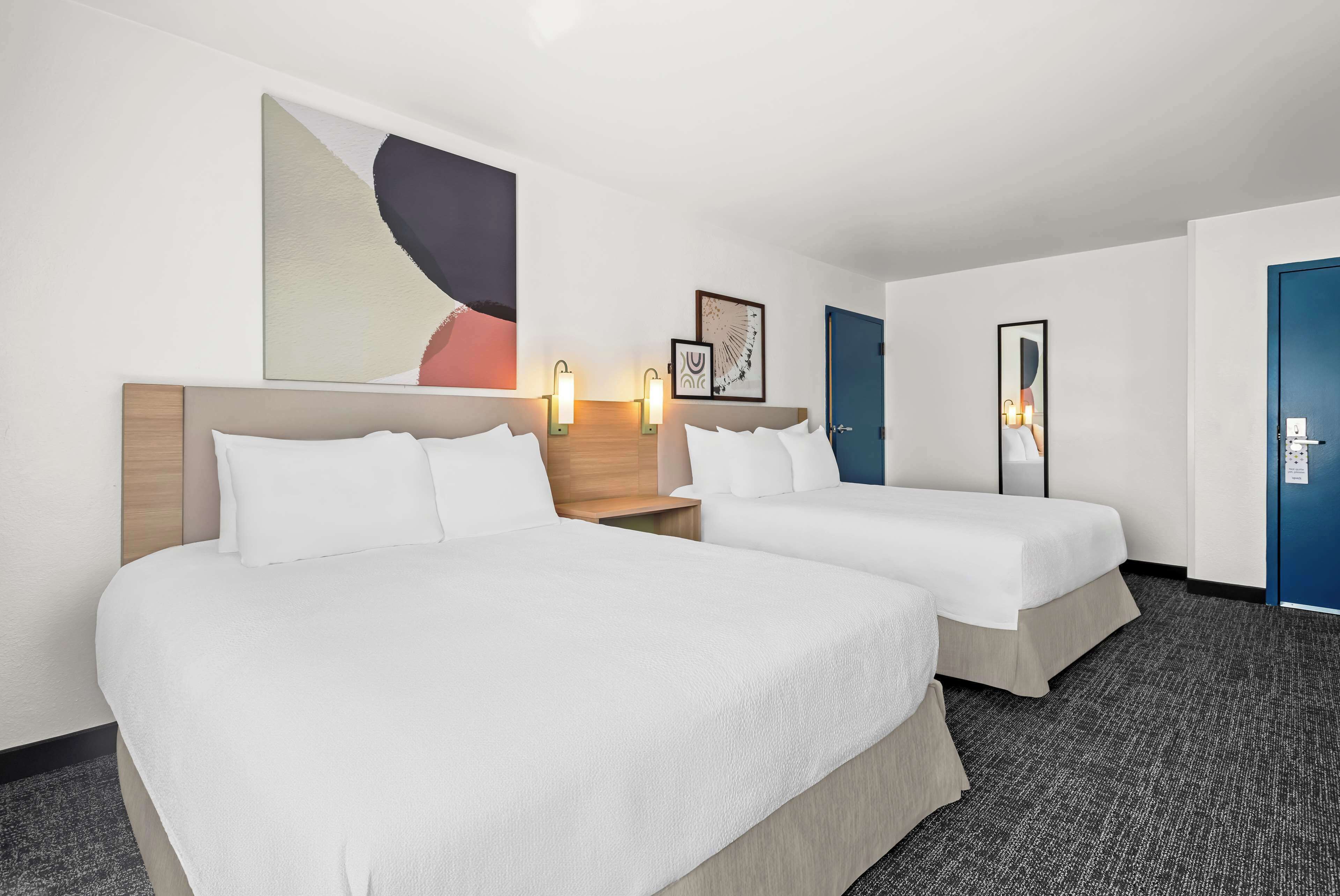 premium bedding, pillow-top beds, desk, laptop workspace