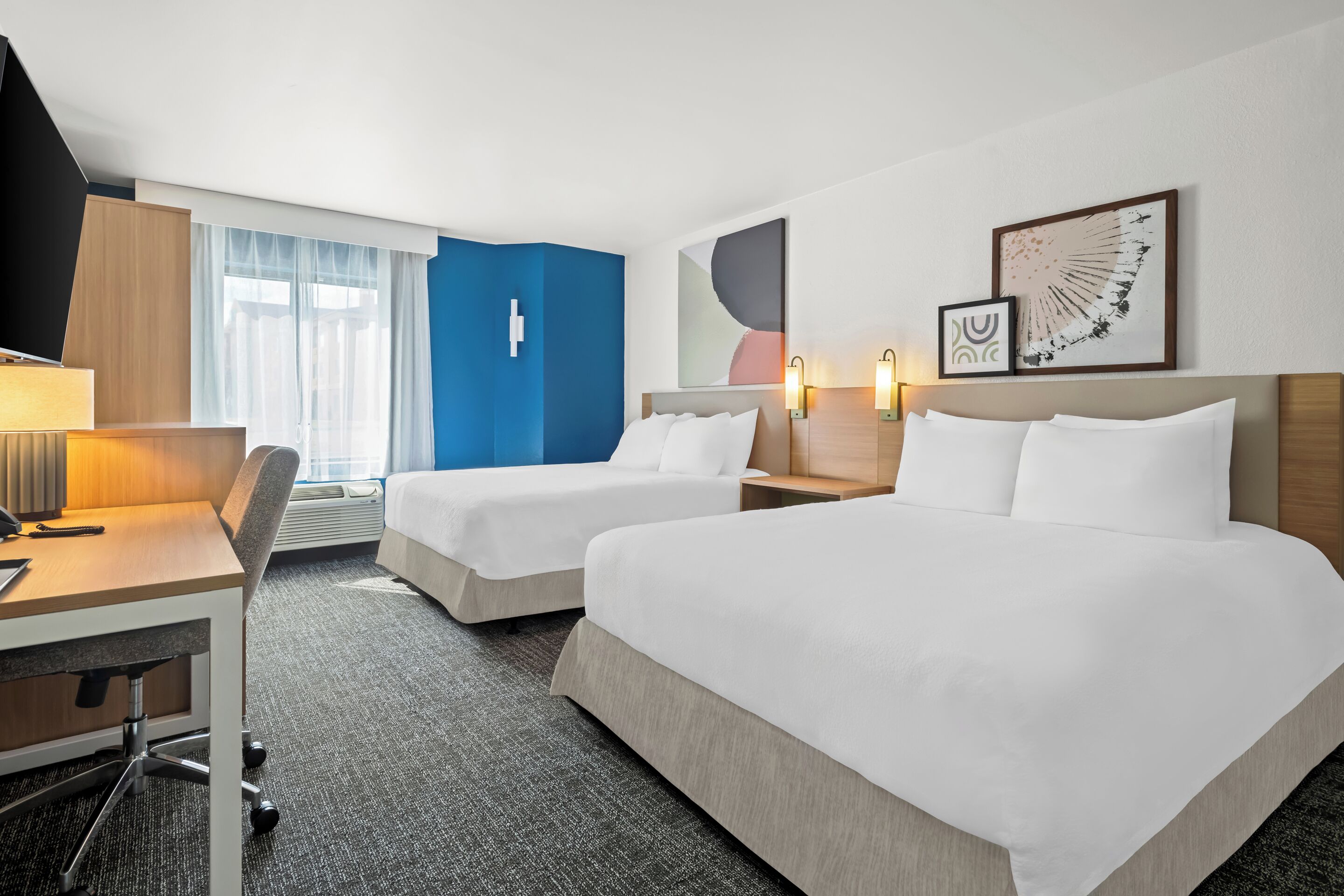 premium bedding, pillow-top beds, desk, laptop workspace