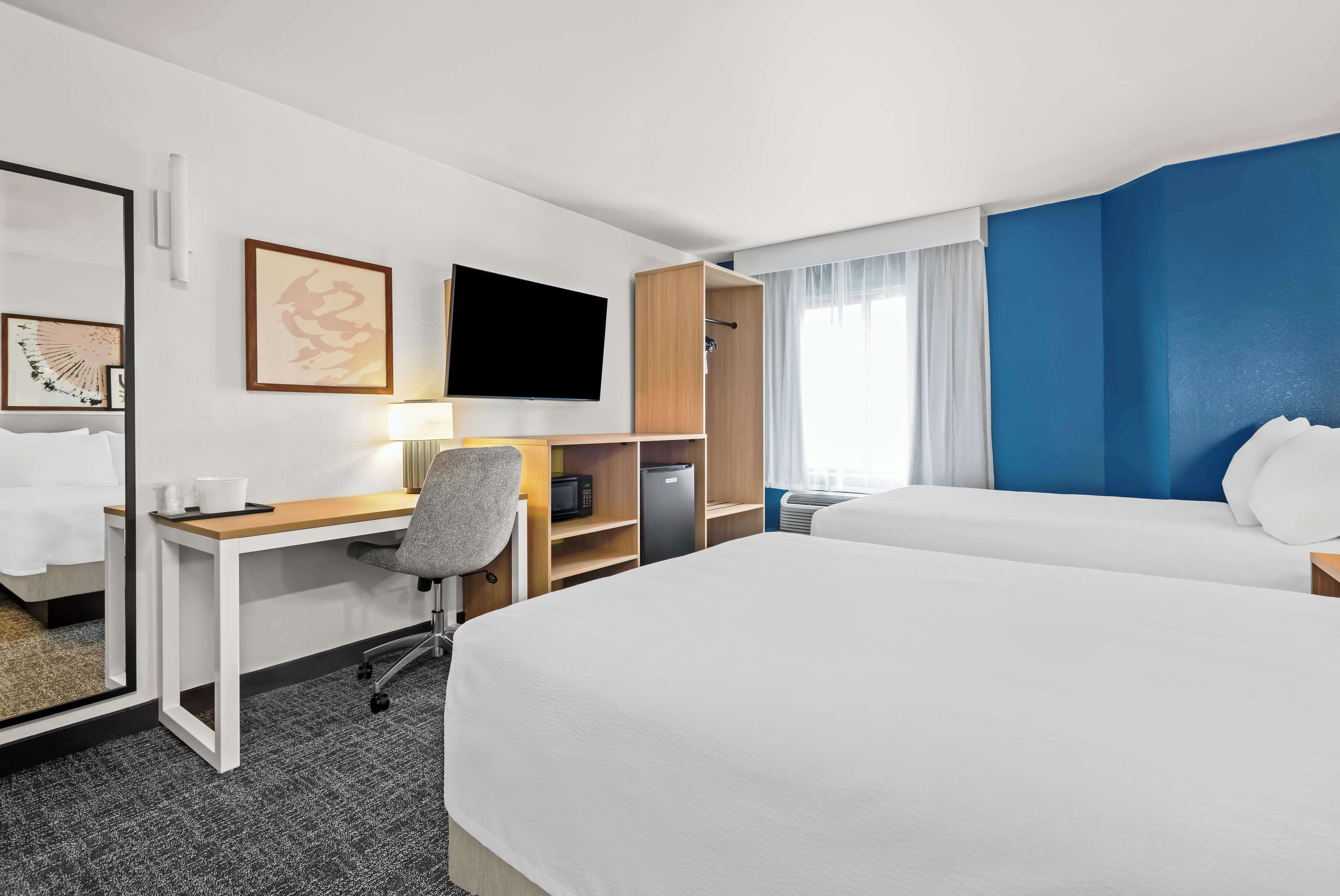 premium bedding, pillow-top beds, desk, laptop workspace