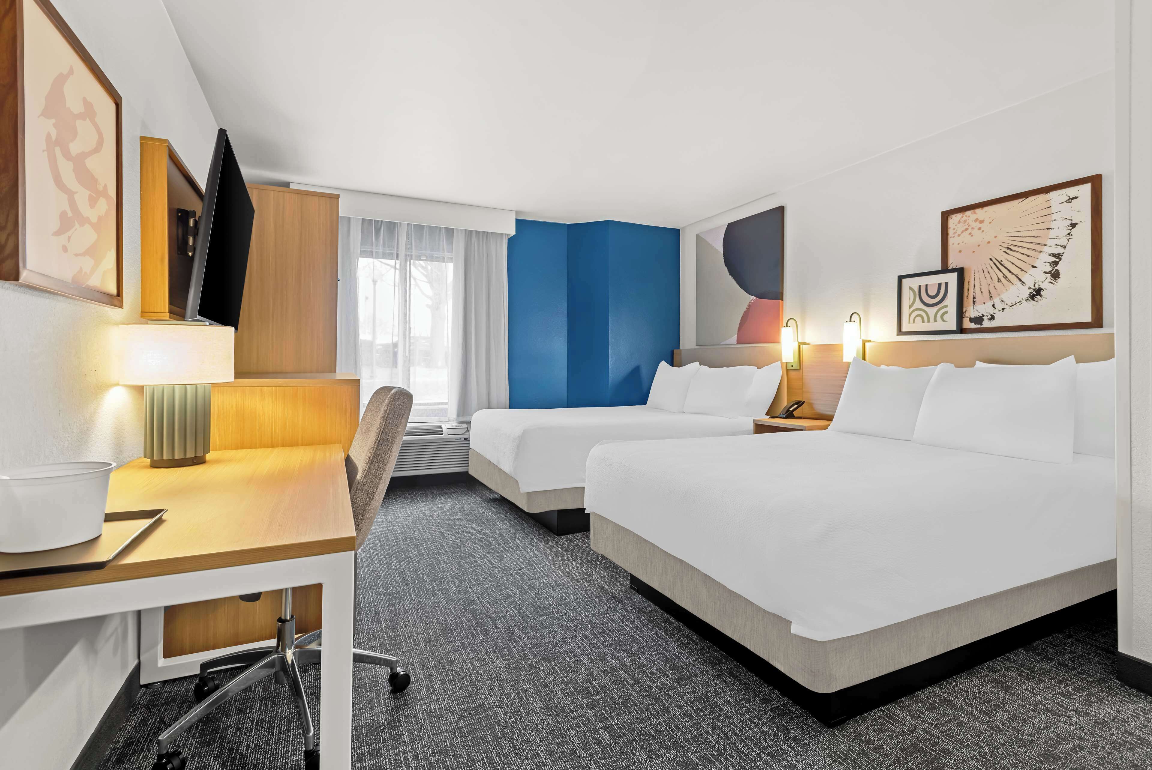 premium bedding, pillow-top beds, desk, laptop workspace