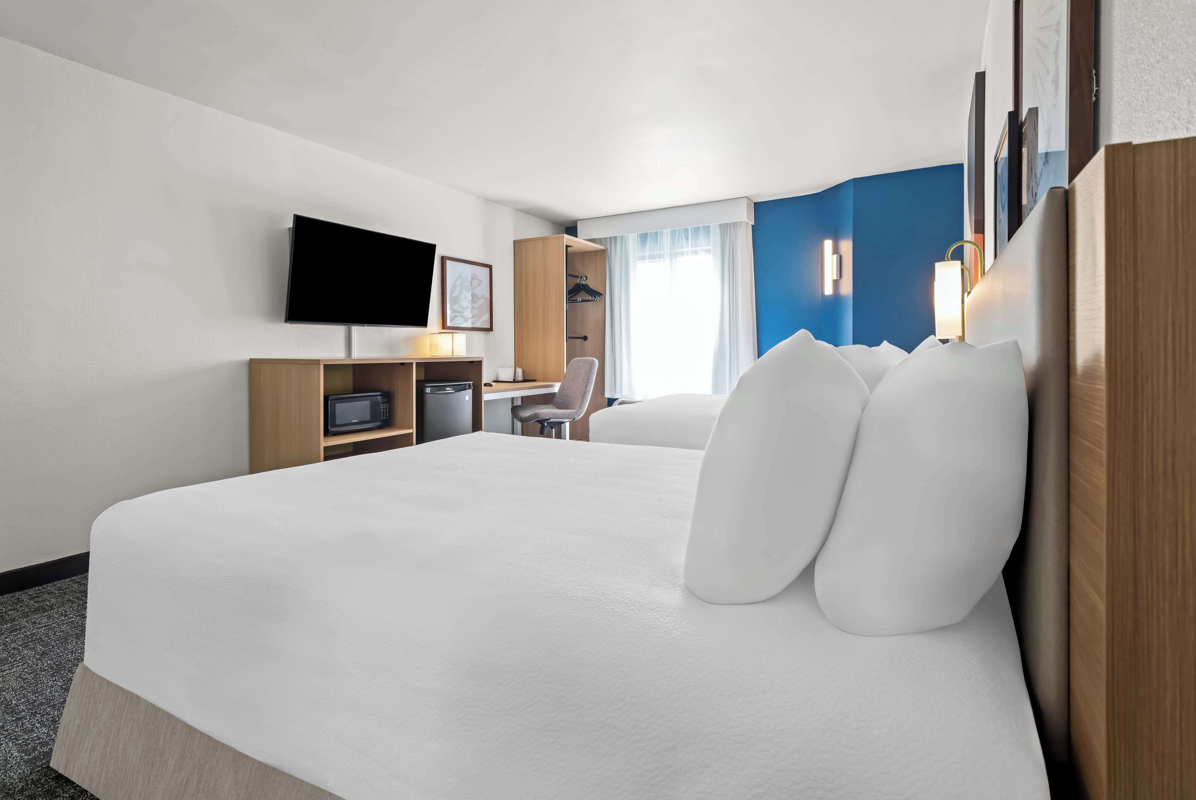 premium bedding, pillow-top beds, desk, laptop workspace