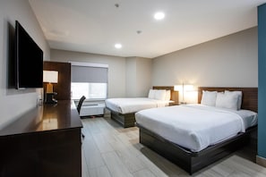 A hotel room with two beds, a desk, a flat-screen TV, and a window with blinds. - Sleep Inn Phoenix North I-17 (Phoenix)
