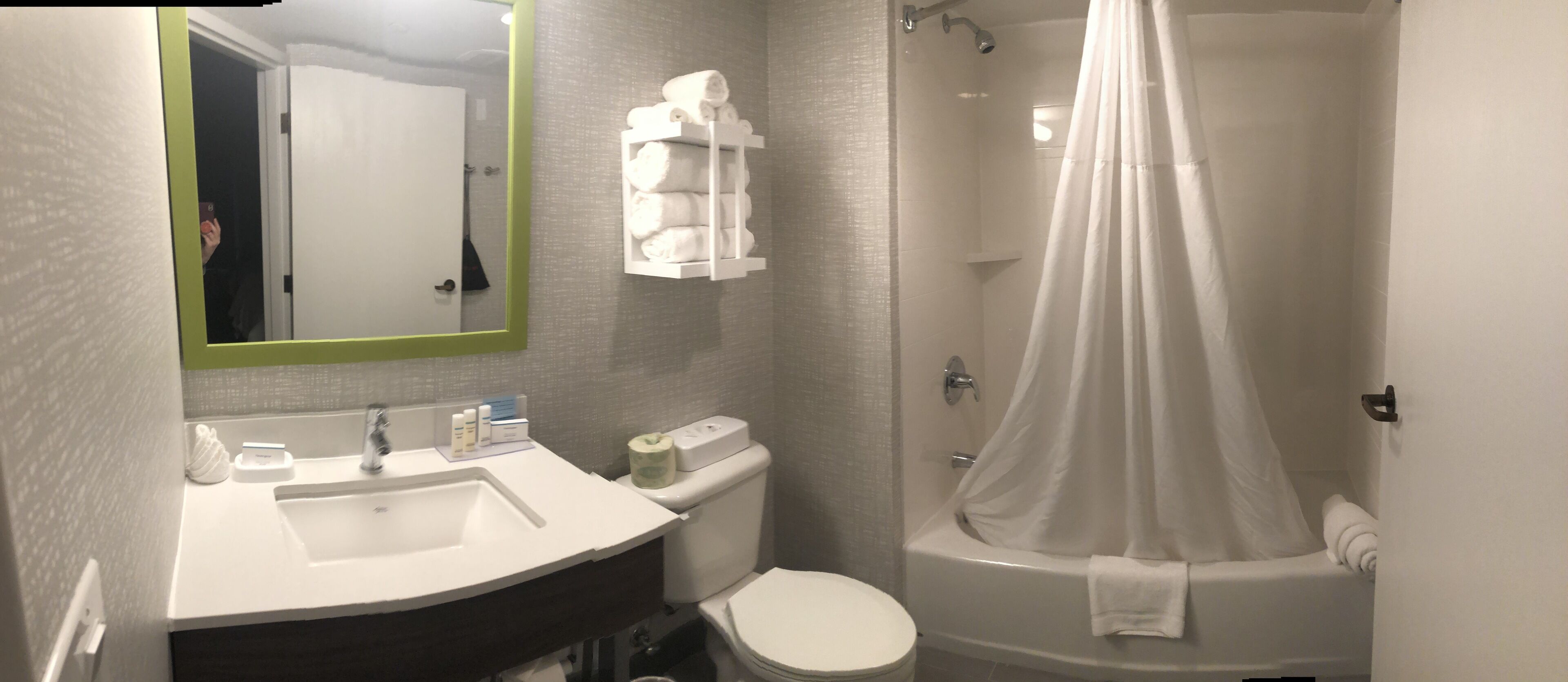 A bathroom with a sink, toilet, and shower.