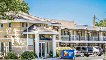 Situated on a quiet street, this hotel offers a two-story building with a flat roof and windows on the upper level.