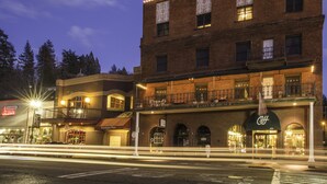 A multi-story building with a sign reading "CARY HOUSE" and a storefront below. - Historic Cary House Hotel (Placerville)
