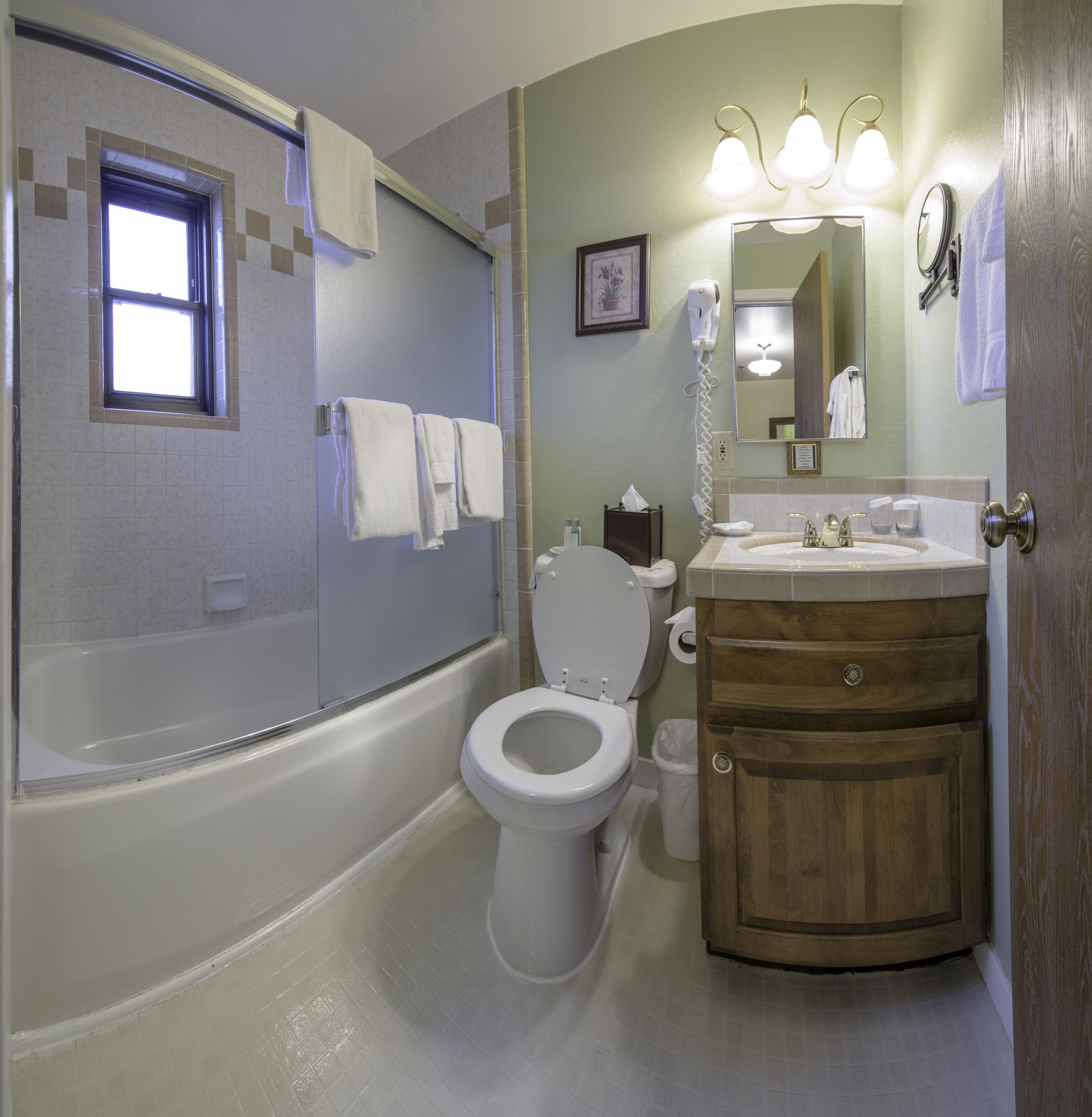 superior suite, 1 king bed, kitchenette | bathroom | combined shower/bathtub, free toiletries, hair dryer, towels