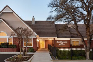 A residential building with a brick facade, a sign reading "Residence In Marriot," and a gated entrance. - Residence Inn by Marriott Roseville (Roseville)