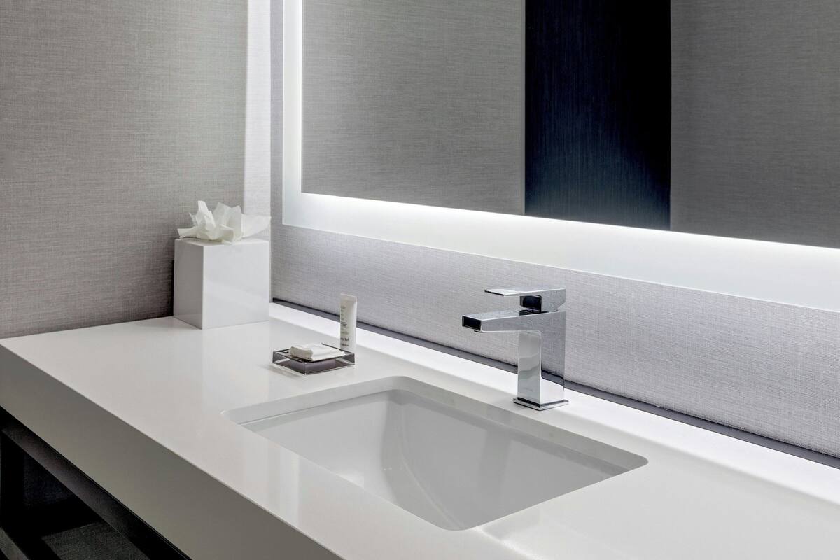 combined shower/bathtub, designer toiletries, hair dryer, towels