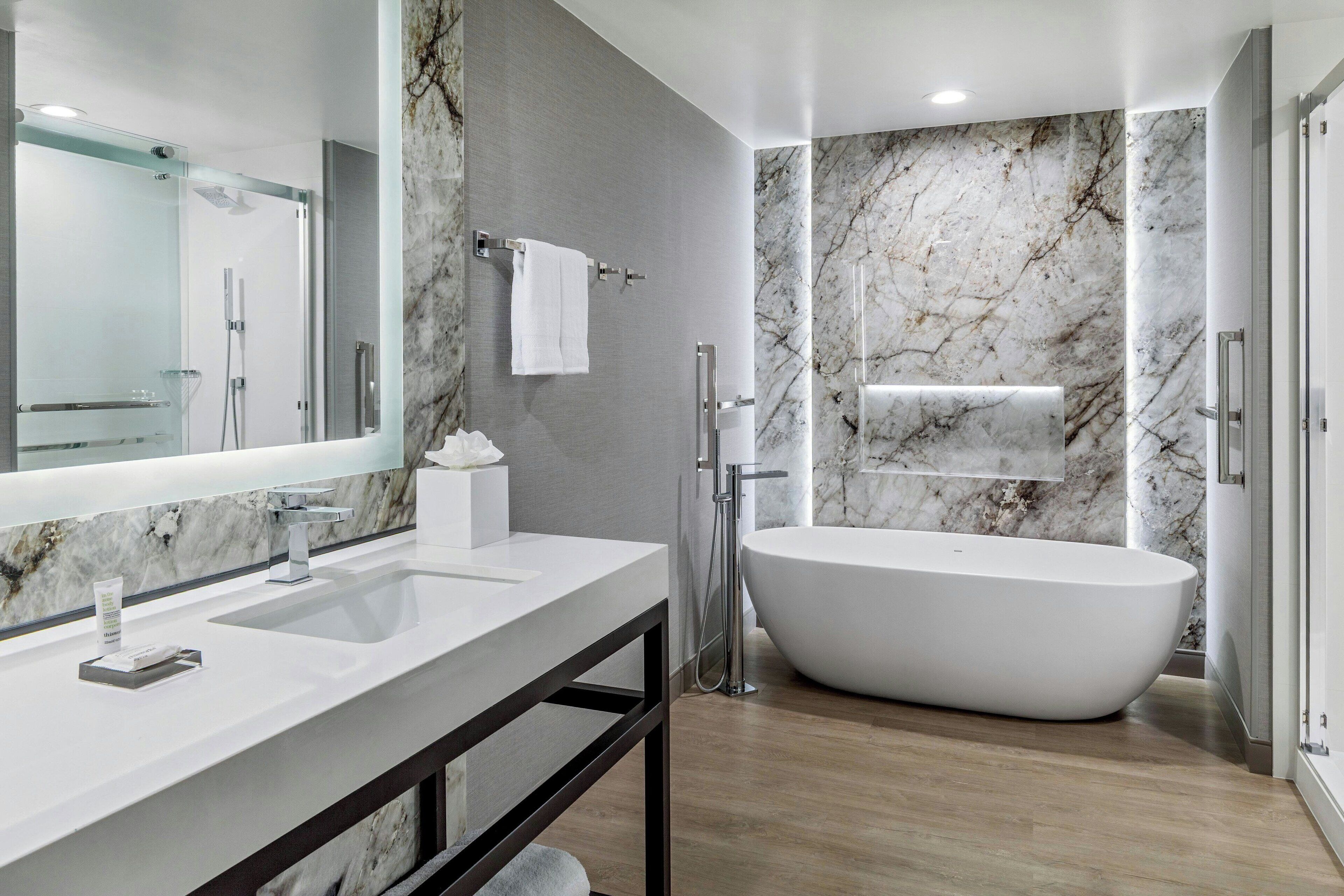 combined shower/bathtub, designer toiletries, hair dryer, towels